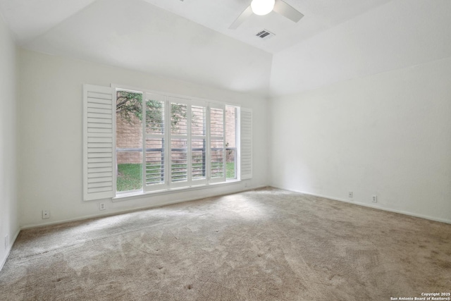 empty room with a ceiling fan, visible vents, lofted ceiling, and carpet