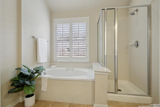 full bathroom with tile patterned flooring, a garden tub, and a stall shower