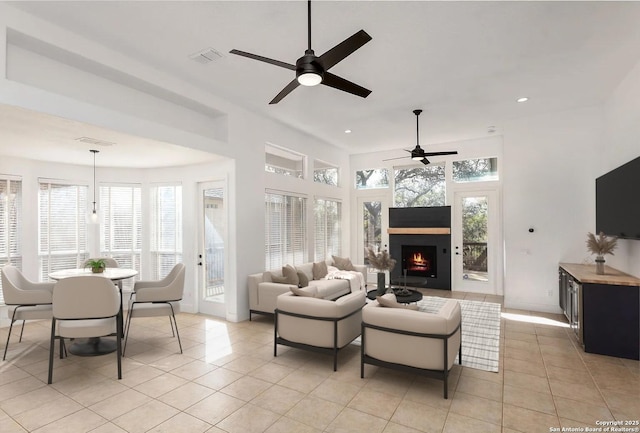 living room with a ceiling fan, a large fireplace, recessed lighting, and light tile patterned flooring