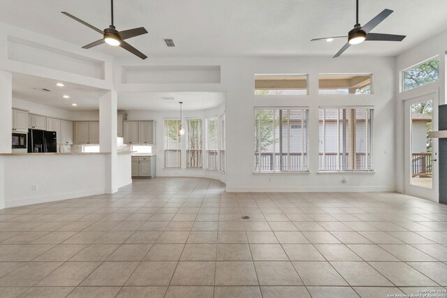 unfurnished living room with a ceiling fan, visible vents, and light tile patterned flooring