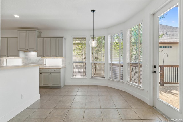 unfurnished dining area featuring light tile patterned floors, baseboards, and recessed lighting