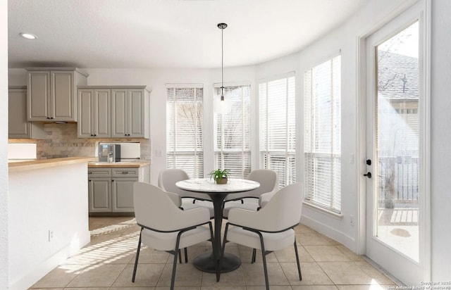 dining space with baseboards, recessed lighting, and light tile patterned flooring