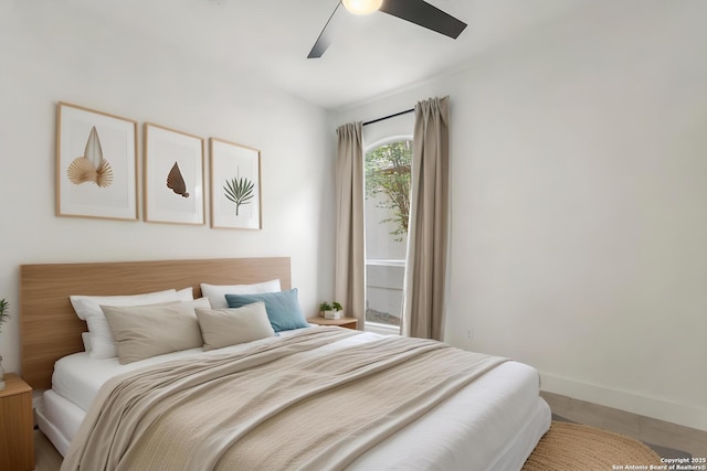 bedroom featuring ceiling fan and baseboards