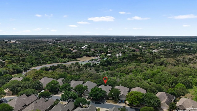 aerial view featuring a forest view and a residential view