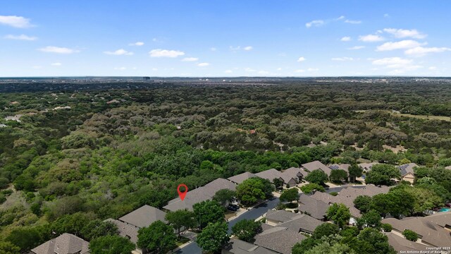 drone / aerial view featuring a forest view and a residential view