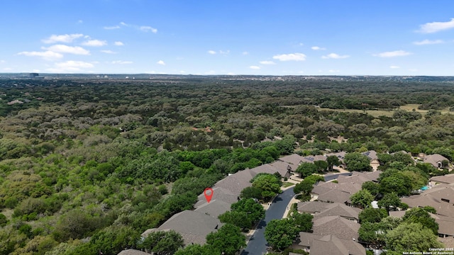drone / aerial view with a residential view and a wooded view