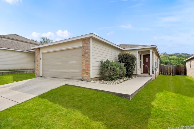 view of front of house featuring a front lawn, concrete driveway, fence, a garage, and brick siding