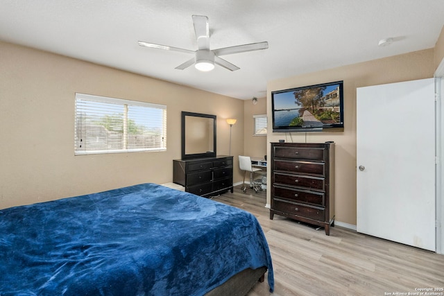 bedroom featuring baseboards, a ceiling fan, and wood finished floors