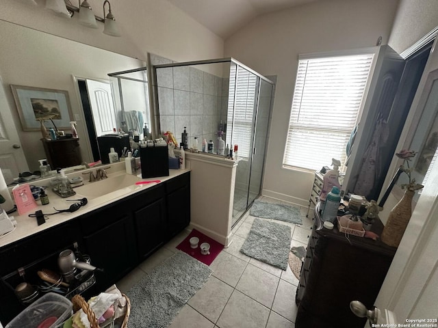 full bath with vaulted ceiling, vanity, tile patterned floors, and a stall shower