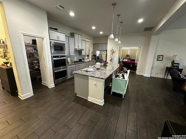 kitchen featuring visible vents, dark wood-type flooring, appliances with stainless steel finishes, and gray cabinets
