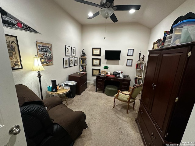 carpeted home office with a ceiling fan and vaulted ceiling