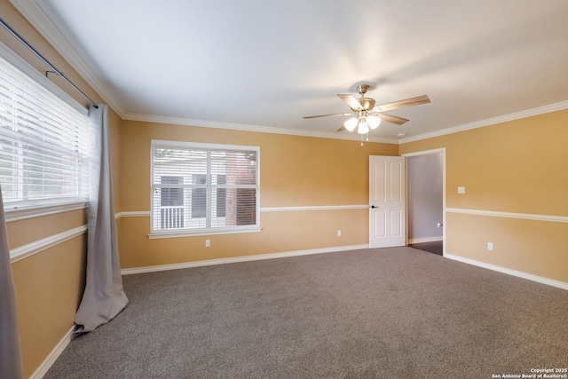 carpeted empty room with a ceiling fan, baseboards, and ornamental molding