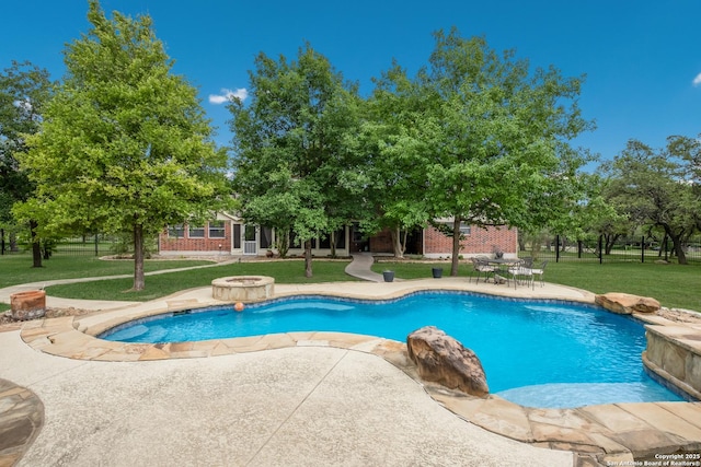 pool with a lawn and a patio