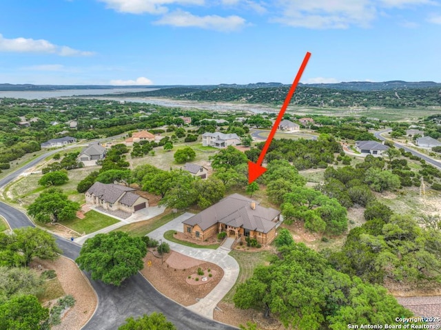 drone / aerial view featuring a residential view and a water view