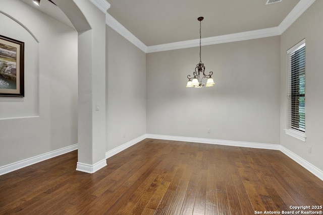 unfurnished room featuring crown molding, a notable chandelier, and dark wood-style flooring