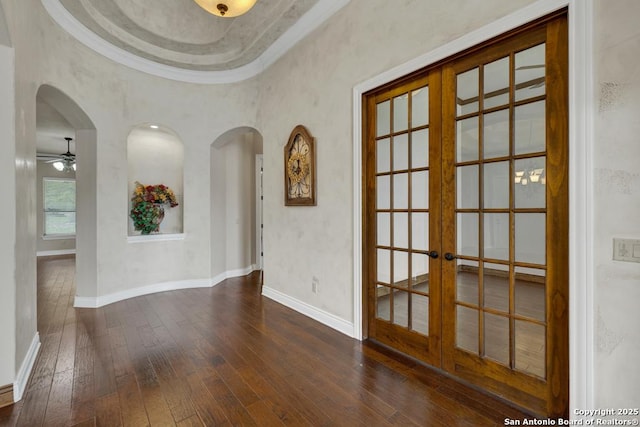 empty room featuring baseboards, a ceiling fan, french doors, and hardwood / wood-style floors