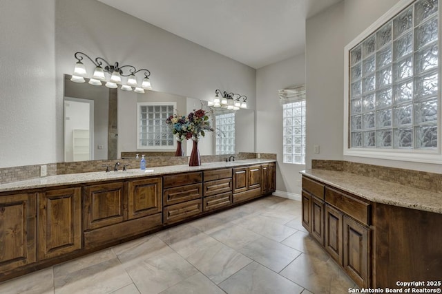 bathroom featuring a sink and double vanity
