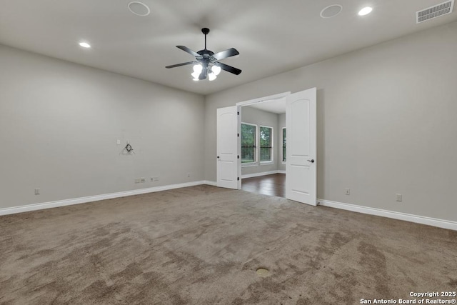 carpeted spare room with baseboards, visible vents, recessed lighting, and ceiling fan