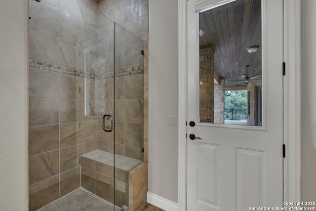 full bathroom with baseboards and a stall shower