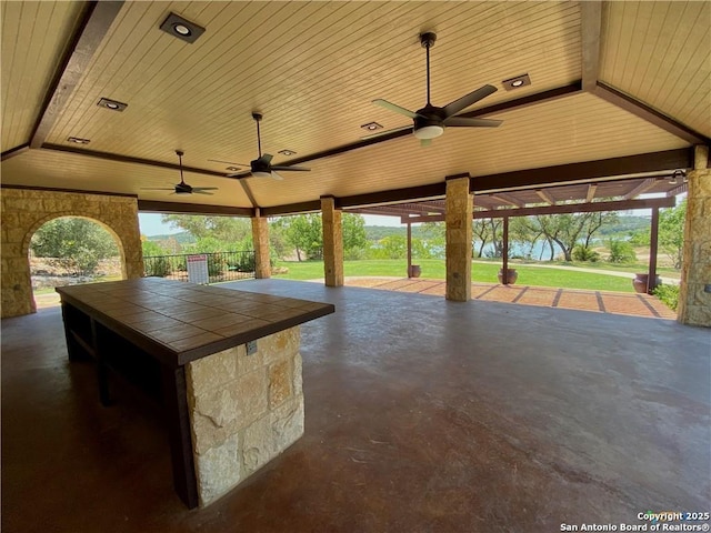 view of patio with a ceiling fan and fence