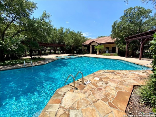 community pool with a pergola and a patio