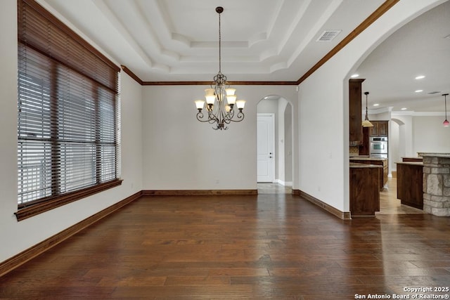 unfurnished dining area featuring a chandelier, arched walkways, a raised ceiling, dark wood-type flooring, and visible vents