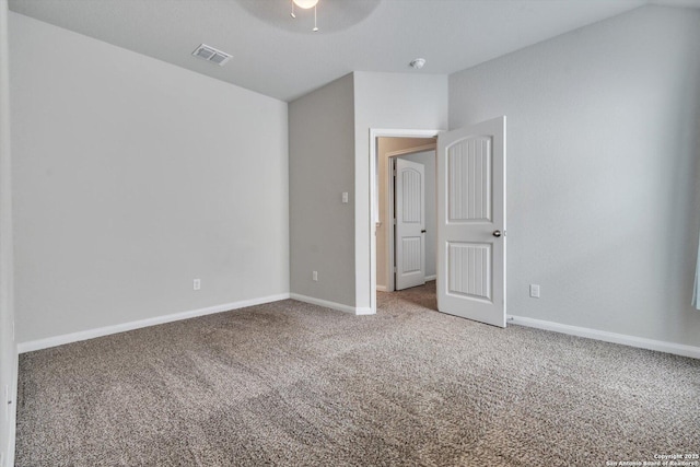 unfurnished bedroom with carpet floors, a ceiling fan, visible vents, and baseboards