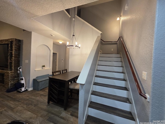 12031 Mill Love, San Antonio, TX 78254 - stairs with a textured wall, wood finished floors, a chandelier, baseboards, and a textured ceiling