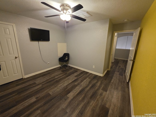 12031 Mill Love, San Antonio, TX 78254 - empty room featuring a textured ceiling, dark wood-style floors, ceiling fan, a textured wall, and baseboards