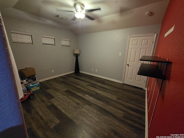 12031 Mill Love, San Antonio, TX 78254 - unfurnished room with a ceiling fan, dark wood-style floors, a textured wall, vaulted ceiling, and baseboards