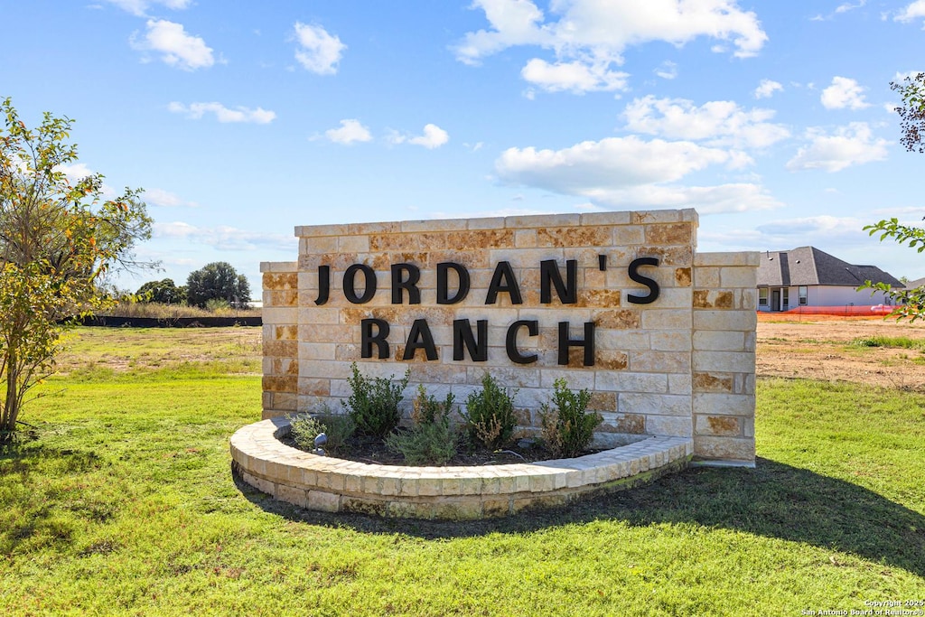 community / neighborhood sign with a lawn