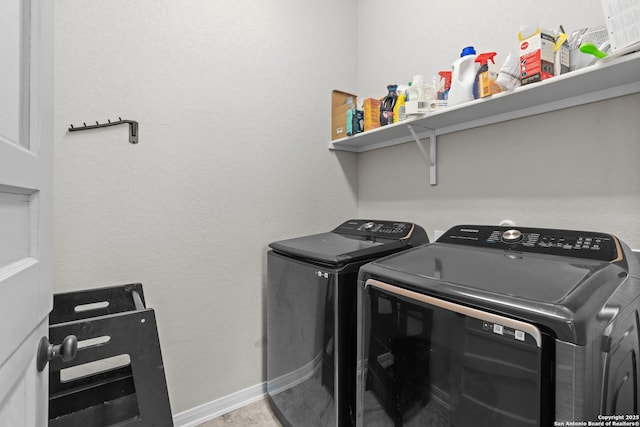 laundry room with separate washer and dryer, baseboards, and laundry area