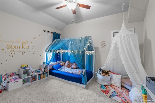 bedroom with ceiling fan, carpet floors, and vaulted ceiling