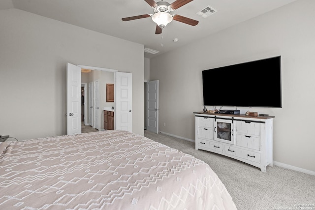 carpeted bedroom with visible vents, a ceiling fan, baseboards, and ensuite bathroom