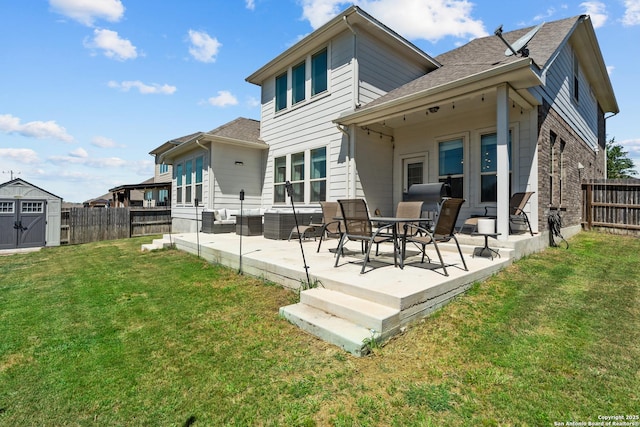 rear view of property featuring a patio area, a fenced backyard, and a storage unit