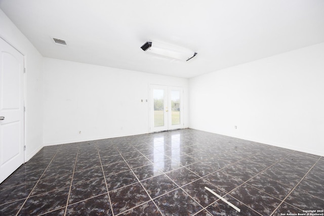 spare room with baseboards, french doors, visible vents, and marble finish floor