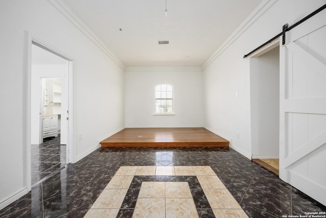 interior space featuring baseboards, marble finish floor, ornamental molding, and a barn door