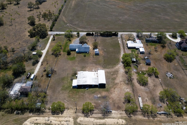 birds eye view of property with a rural view