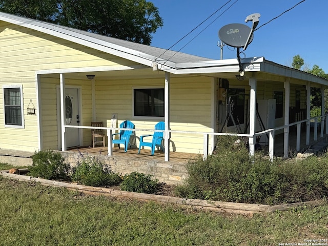 back of property with covered porch