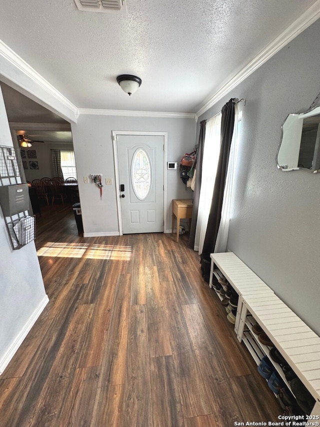 entryway featuring crown molding, visible vents, wood finished floors, ceiling fan, and a textured ceiling