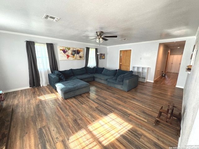 living area with ceiling fan, visible vents, a healthy amount of sunlight, and wood finished floors