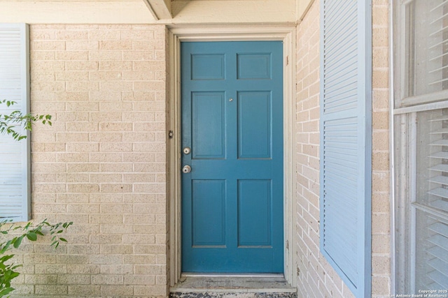 324 Craddock, San Marcos, TX 78666 - doorway to property with brick siding