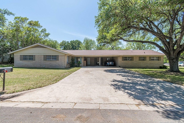 324 Craddock, San Marcos, TX 78666 - ranch-style home featuring brick siding, driveway, a front lawn, and an attached carport