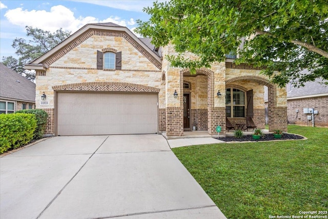 french country inspired facade featuring concrete driveway, stone siding, a porch, a front yard, and a garage