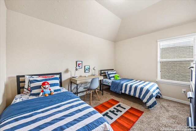 bedroom featuring vaulted ceiling, baseboards, and carpet