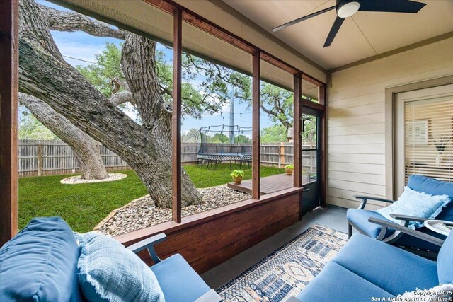 sunroom featuring a ceiling fan and plenty of natural light
