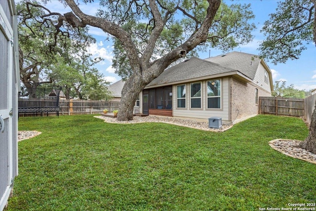 view of yard with a fenced backyard and a sunroom