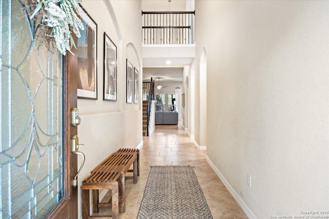 entryway featuring arched walkways and baseboards