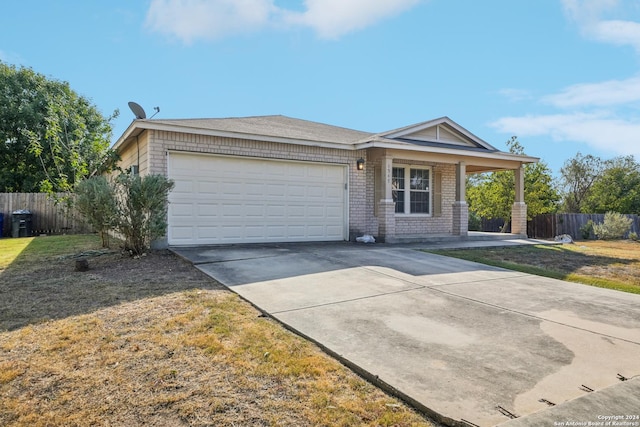 ranch-style home with a porch, brick siding, fence, a garage, and concrete driveway