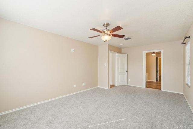 unfurnished bedroom with visible vents, ceiling fan, carpet floors, and baseboards